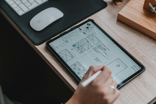 UI UX designer mapping out user experience flows on a wall